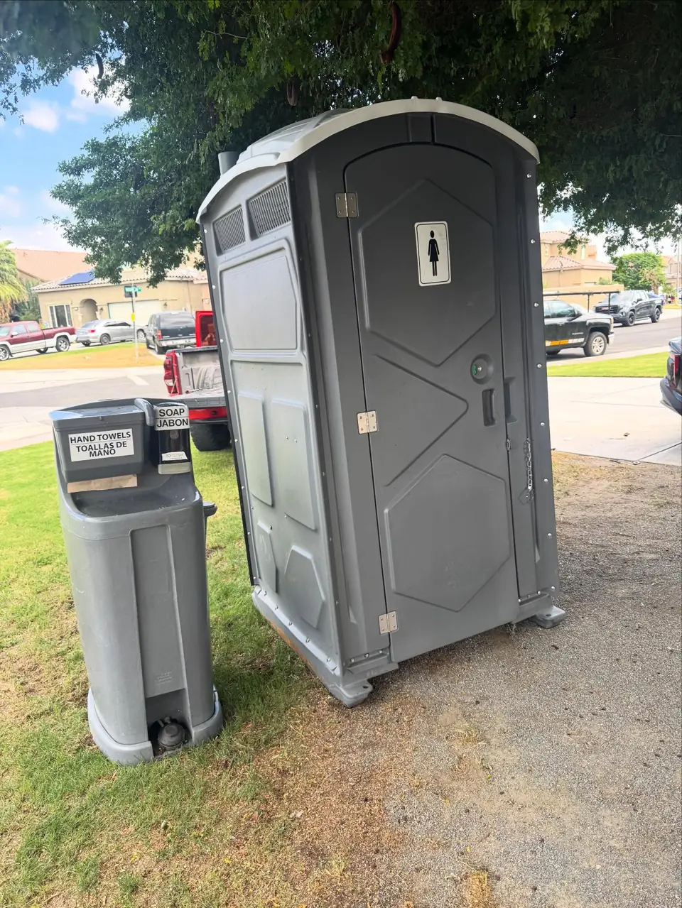 Portable toilet and hand washing station on grass